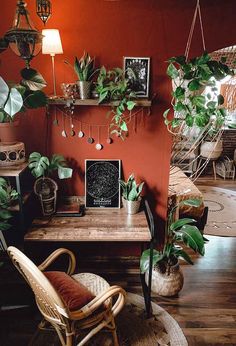 a living room filled with lots of plants and decor on top of a wooden table