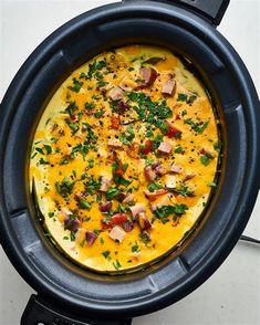 an omelet with ham, cheese and parsley in a crock pot