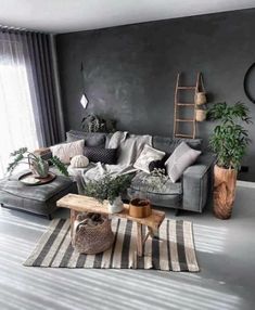 a living room filled with furniture and plants