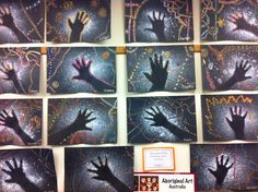 handprints are displayed on the wall in front of other pictures and information cards