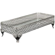 an ornate glass tray with metal legs