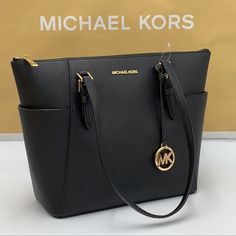 Michael Kors Charlotte Large Leather Top-Zip Tote Tote Bag Black 100% Leather Gold-Tone Hardware 15”W X 10”H X 4.75”D Handle Drop: 10” Exterior Details: 2 Side Slip Pockets Interior Details: Back Zip Pocket, 2 Front Slip Pockets Lining: 100% Polyester Zip Fastening Imported Michael Kors Black Shoulder Bag With Zipper, Michael Kors Black Shoulder Bag With Zipper Closure, Michael Kors Black Bag With Zipper Closure, Michael Kors Leather Shoulder Bag With Zipper Pocket, Designer Michael Kors Bag With Zipper Closure, Michael Kors Bags With Zipper Pocket, Michael Kors Office Bag With Zipper Closure, Mk Purse, Tan Bag