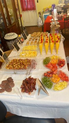 an assortment of food on a table at a party or gathering, ready to be eaten