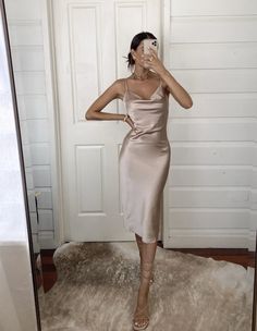 The Aspen Midi Dress in Champagne Satin is the perfect style for an upscale event, be it worn as a wedding guest dress, cocktail party dress or social occasion. -Cowl Neck Midi Satin Slip Dress -Adjustable thin spaghetti strap -Lightweight fabric -Back center leg slit -Slip-On Dress, no zipper -Fabric has slight stretch -Size Tip: Please use the attached size guide for sizing -Polyester satin, cold water hand wash only -Length in size 2 is 44" -Our Model, Briana, is 5'9 wearing a US size 4 -We e Champagne Outfit Casual, Beige Satin Cocktail Dress, Slip Dress Aesthetic, Wedding Guest Dress Cocktail, Dress Cocktail Party, Bachelorette Party Dress, Champagne Dress, Rehearsal Dinner Dresses, Dress With Stockings