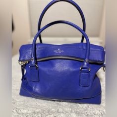 This Pre-Loved Kate Spade Is Gorgeous! With It’s Beautiful Royal Blue Color, It Is Clean In And Out. Has 2 Compartments. One Large Zip Compartment, And Open Compartment Houses 2 Open Pockets And One Zipper Pocket. Classic Kate Spade Satin Interior. Measures Approx. 14” Wide X 11 1/2” Tall With A 5” Depth. Use Your Favorite Crossbody Strap. In Euc! Not A Scratch On It! Royal Blue Color, Kate Spade Bag, Blue Leather, Zipper Pocket, Leather Purses, Royal Blue, Kate Spade, Satchel, Zipper