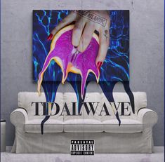 a couch in front of a wall with a painting on it that says tidalwave