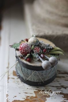 an old tin can with candy and decorations on the top, sitting on a table