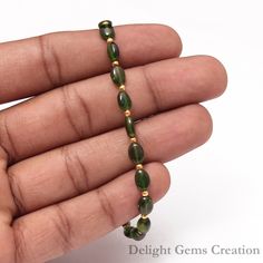 PRODUCT DETAIL : ITEM : CHROME DIOPSIDE BEADED NECKLACE ITEM CODE : DGC2495 ITEM NAME :NECKLACE GEMSTONE : CHROME DIOPSIDE BEADS SHAPE : SMOOTH OVAL BEADS LENGTH : 7.5 INCH APPROX BEADS SIZE: 5x6mm - 5x7mm Approx WEIGHT : 30 Cts. APPROX CUSTOMIZATION/BULK ORDER : AVAILABLE PLEASE FEEL FREE TO CONTACT IF YOU REQUIRE ANY FURTHER INFORMATION. Green Oval Beads Bracelet As A Gift, Adjustable Green Metal Bracelets, Adjustable Gold-plated Green Jewelry, Adjustable Green Multi-strand Beaded Bracelets, Vibrant Green Adjustable Bracelets, Green Metal Clip-on Jewelry, Halloween Beaded Jewelry, Faceted Bead Necklace, Green Chrome