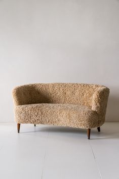 a couch sitting on top of a white floor