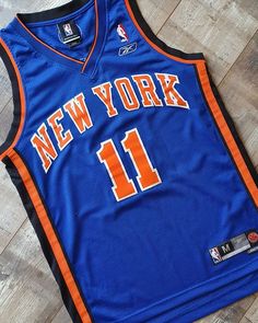 the new york basketball jersey is on the floor in front of a wood flooring area