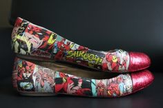 the shoes are decorated with comic characters on them, and have red metallic toe covers