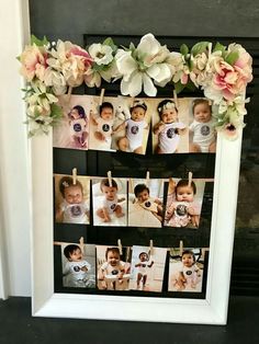 a white frame with flowers and photos hanging on it