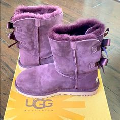 Never Worn. Slight Blemish On The Left Boot, See Up Close Pic. Suede Upper. Pull On Style. Pair Of Satin Bows On Back Of Boot. Plush Lining Is Genuine Shearling. Purple Ugg Boots, Ugg Boots Outfit, Uggs With Bows, Ugg Bailey Bow, Bailey Bow Uggs, Bow Boots, Ugg Bailey, Bailey Bow, Purple Bows