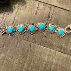 a bracelet with turquoise heart charms on it