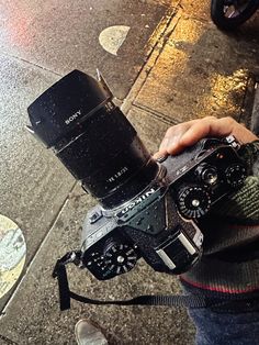 a person holding up a camera on the street