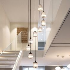 a living room filled with furniture and lots of lights hanging from it's ceiling