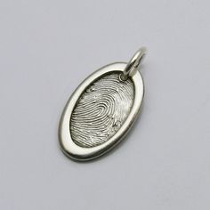 Keep your loved one with you always, with this unique oval fingerprint pendant. Handcrafted in solid sterling silver, this pendant features a beautiful asymmetrical heart design with a dimensional border. The raised border surrounding the fingerprint accentuates its importance and draws attention to your loved one's fingerprint. The smooth edges and shiny finish of the pendant give it a sophisticated touch, making it suitable for any occasion, whether casual or formal. This design is intended to Thumb Print, Modern Silver Jewelry, Fingerprint Necklace, Handwriting Jewelry, Fingerprint Jewelry, Unique Gifts For Women, Keepsake Jewelry, Bar Pendant, Memorial Jewelry