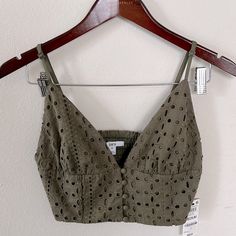 Brand New Burnt Olive Green Crop Top From The Brand Bar Lll. It Has Buttons In The Front And Adjustable Straps. It Also Has A V-Neck And Has Material That Stretches In The Back. Was Only Tried On But Never Worn Out. Size: Medium Materials: Shell-100% Cotton; Lining-100% Polyester Bust Measurement: About 15 Inches Length Of Front: Almost 5 Inches Length From Straps: About 11 Inches Olive Green Crop Top, Glitter Crop Top, Gold Crop Top, Knot Crop Top, Flower Tie, Sheer Crop Top, Cropped Crewneck, Green Crop Top, Mesh Crop Top