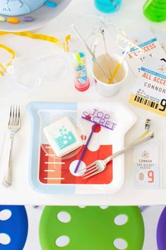 the table is set up with colorful plates and utensils