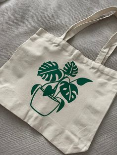 a white bag with a green plant on it