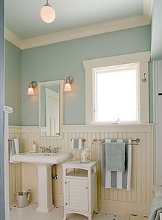 a bathroom with blue walls and white fixtures