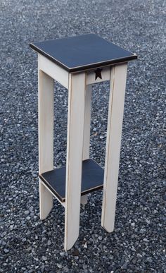 a small wooden table sitting on top of gravel