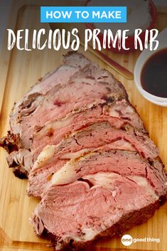 a piece of meat sitting on top of a cutting board next to a cup of coffee