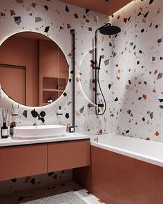 a bathroom with a round mirror above the sink and a bathtub next to it