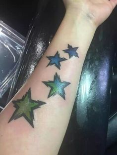 a woman's arm with five stars on it