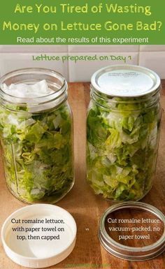 two mason jars filled with lettuce on top of a wooden table