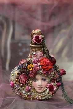 a woman's head is covered in flowers and beads