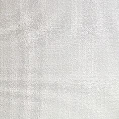 a white textured wall with small squares on it