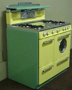 a green and yellow stove top oven next to a wall