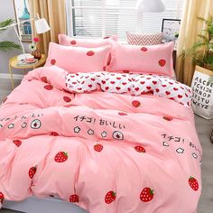 a bed with pink sheets and strawberrys on it