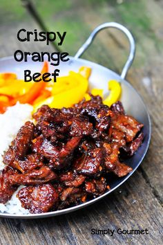 an image of a plate of food with rice and peppers on it that says crispy orange beef