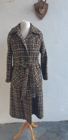 "Vintage 50s 60s heavy tweed wool mix brown taupe and cream tweed wool coat fully lined  with raglan sleeve and matching belt.  Beautifully tailored coat with two large patch pockets. Size large Measurements are approximate and are taken laid flat (bust/chest/waist/hips are then doubled) make sure to leave yourself some \"wiggle room\". Label: unbranded Condition:  Excellent Fabric:  60% wool  25% nylon 10 acrylic - tweed Mannequin size UK 14 Fits like large - UK 14 bust 42\" waist 42\"\" Hips 48\" Shoulder to hem 44\" DELIVERY INCLUDING INTERNATIONAL DELIVERY - I COMBINE POSTAGE SO WHEN YOU PURCHASE MORE THAN ONE ITEM YOU WILL ONLY HAVE TO PAY FOR THE DELIVERY COST OF ONE ITEM.  So you can save money on your postage by ordering more than one item at the same time. Please Visit my new ETSY Brown Belted Wool Coat For Winter, Fitted Brown Wool Coat For Fall, Brown Tweed Wool Long Coat, Brown Tweed Long Wool Coat, Retro Brown Tweed Outerwear, Vintage Wool Coat For Fall, Vintage Brown Long Wool Coat, Vintage Wool Coat For Workwear In Fall, Vintage Tweed Outerwear For Winter