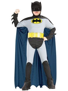 a young boy dressed as batman standing with his hands in the air while wearing a costume