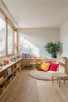 a living room filled with furniture and a potted plant on top of a window sill