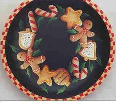 a plate with gingerbread cookies and candy canes in the shape of a wreath