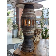 an old fashioned lamp sitting on top of a wooden table