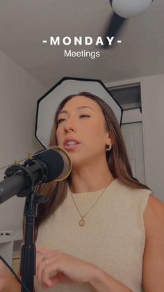 a woman singing into a microphone with the words monday - meetings above her head