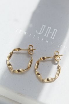 A minimalist design bursting with character! Whether its work or social, these stunning 14K Gold Hoop Earrings will compliment the occasion. The twisted design adds that extra wow factor to brighten up any outfit. Very easy and comfortable to wear, an essential for your jewellery box! Gold butterfly backs provided. - 15mm in diameter - Handmade using 18k Gold and 925 Sterling Silver. - Very secure and comfortable - Butterfly Backs provided - The hoops are designed and produced using the highest Dainty Gold Earrings, 14k Gold Hoop Earrings, Twisted Hoop Earrings, Unique Handcrafted Jewelry, Dainty Hoop Earrings, Small Gold Hoops, Bohemian Jewellery, Unique Jewelry Gifts, Earring Box