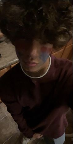 a young boy with curly hair in the kitchen