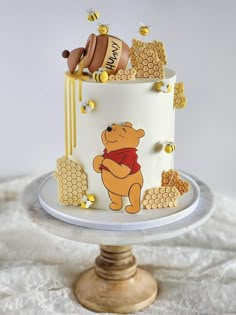 a winnie the pooh cake with honey decorations