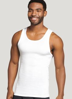 Essential under sweaters, flannels and dress shirts, the legendary Jockey® 100% Cotton Big Man A-Shirt Tank just got even better, now with 100% combed cotton for lasting softness and good looks. The comfy rib knit is enhanced with StayNew technology to reduce pilling and fading so it looks and feels new, whiter and brighter, wash after wash. | Jockey® 100% Cotton Big Man A-Shirt Tank - 3 Pack in White Classic White Cotton Tank Top, Classic Solid Color Crew Neck Tank Top, Classic Tank Top For Layering, Classic White Tank Top For Daywear, Classic Cotton Tank Top For Daywear, Classic Cotton Shirt For Loungewear, Jockey Mens, Big Men, Dress Shirts