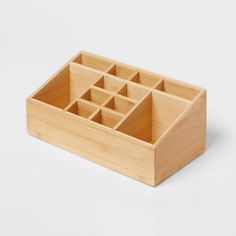 a wooden box that has compartments in it