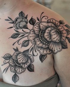 a woman's shoulder with flowers on it