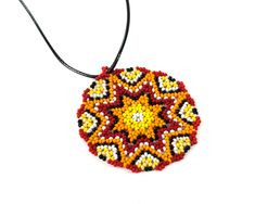 Huichol necklace is handmade from seed beads in Native american style. The size of huichol necklace is 2.4 inches (6 cm). Huichol necklace comes with a cord. Cord has adjustable chain its length - 17.3" - 19.3" (44 cm - max 49 cm). 100% handmade. Made of High Quality Czech beads PACKAGING: Arrives in a white jewelry gift box - ready to be given as a gift. OTHER VARIATIONS Blue mandala pendant - https://www.etsy.com/listing/641699546/mandala-necklace-hippie-pendant-seed?ref=shop_home_active_20 Gr Red Pendant Beaded Necklace For Festivals, Red Amulet Beaded Necklaces With Colorful Beads, Red Artisan Beaded Necklaces For Crafting, Artisan Red Beaded Necklaces For Crafting, Medallion Beaded Necklace As Gift, Handmade Multicolor Beaded Medallion Necklaces, Handmade Multicolor Medallion Beaded Necklaces, Multicolor Handmade Medallion Beaded Necklaces, Handmade Multicolor Medallion Beaded Necklace