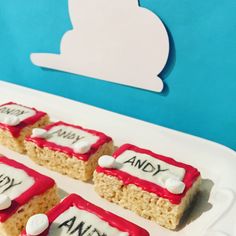 there are four pieces of cake with red and white frosting on them that say andy and andy