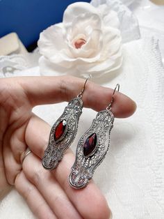 Red Garnet Cubic Zirconia Earrings Iris Design#E2 Custom Made Re-fashioned from an Art Deco pin from the 1920's, I now offer these lovely Antique reproduction earrings in sterling silver. Each stunning bezel set 2.78ct Red Garnet Cubic Zirconia gemstone is 14mm long by 7mm wide. The earrings are 2 1/2 inches long by 11/16th (17mm) wide. Notice the intricate design of the Art Deco filigree setting. A gift box is included and all items are shipped in the box for safe keeping. Feel free to ask ques Ornate Red Drop Earrings, Red Filigree Drop Earrings, Red Filigree Dangle Earrings, Ornate Red Earrings For Party, Ornate Red Filigree Earrings, Red Ruby Earrings With Intricate Design, Victorian Red Oval Earrings, Ornate Red Earrings For Formal Occasions, Red Victorian Jewelry For Evening